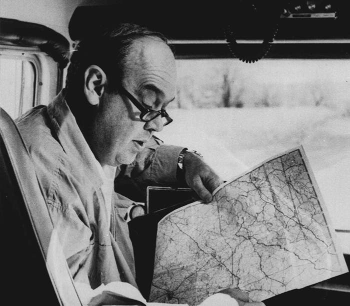 CBS newsman Charles Kuralt is shown reading a map in the driver's seat of his "On The Road" motorhome. (AP Photo/File) 