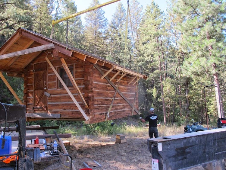 log cabin being placed on foundation
