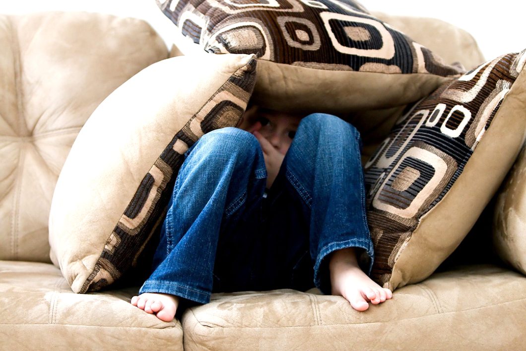 Child on a sofa with pillows