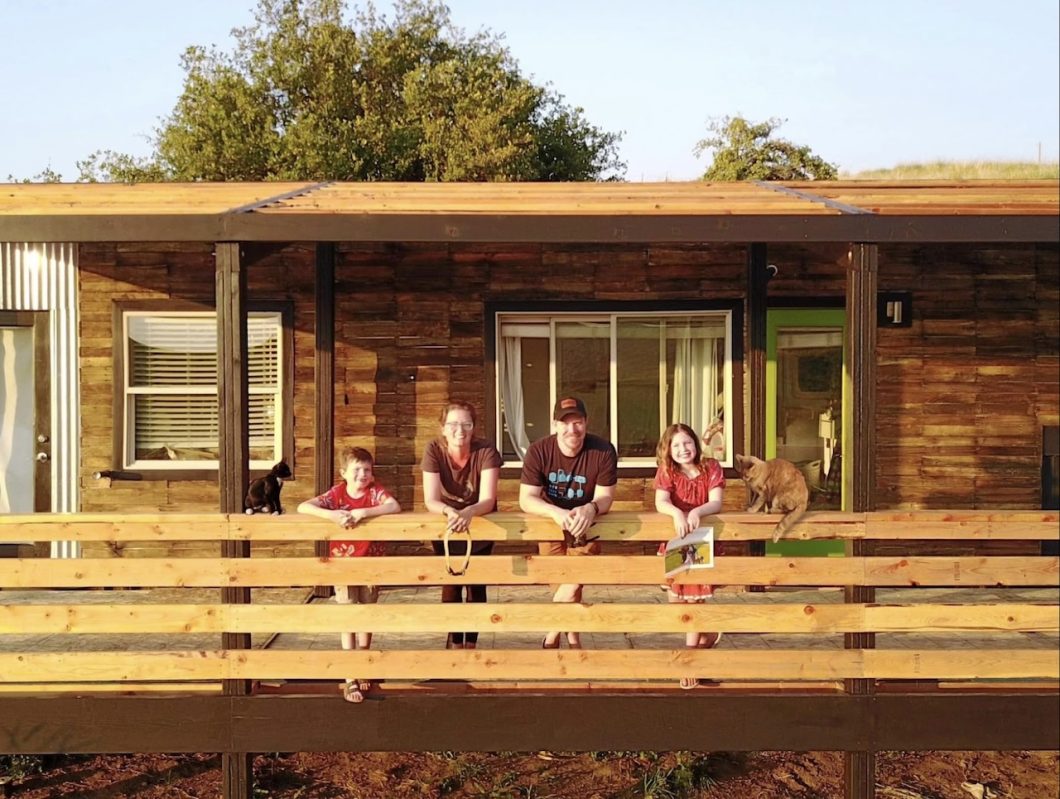 Macy and kids on deck in front of tiny house